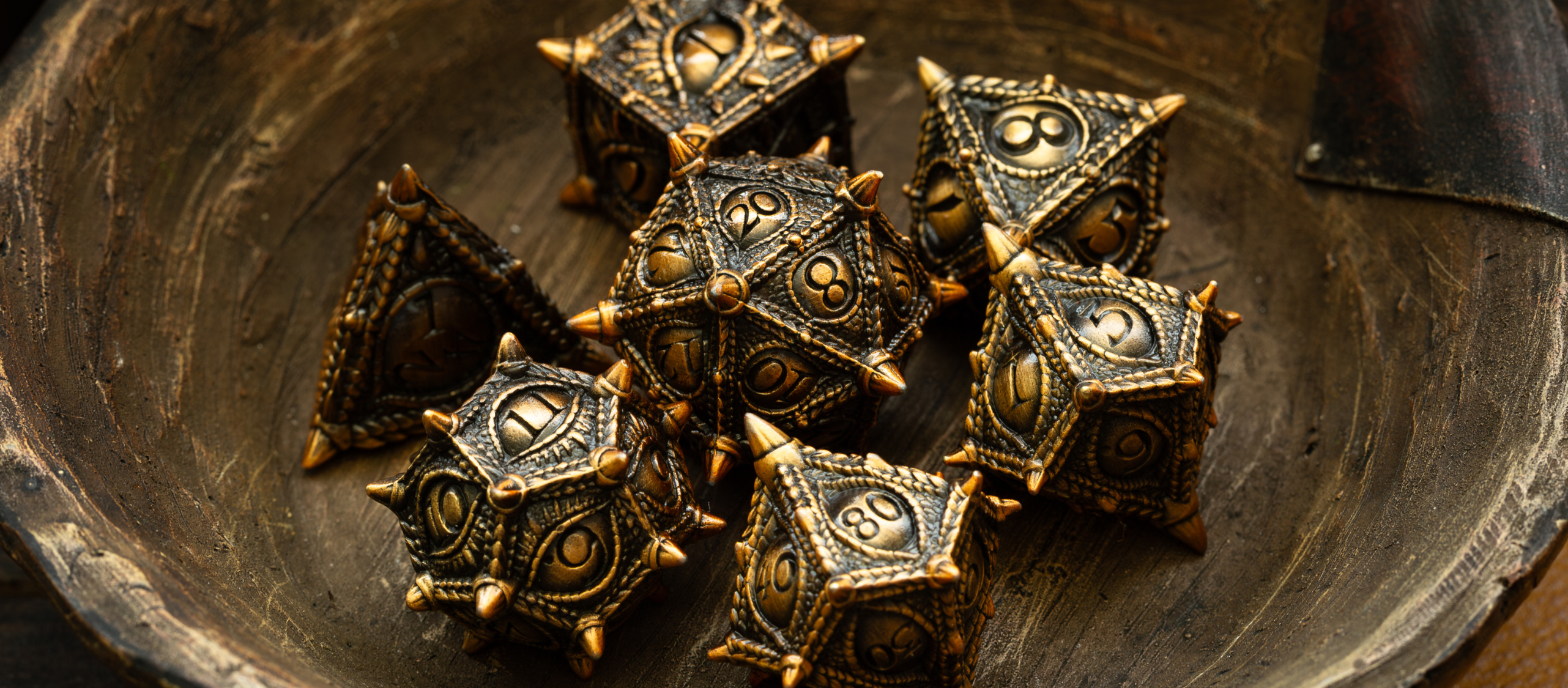 Intricately designed metal DnD dice sets, showcasing powerful designs like dragons, skulls, and shields for precise rolls.